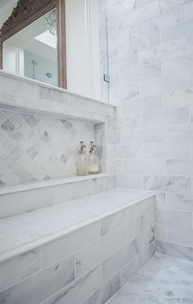 Oversized shower niche in pony wall in carrara marble with quartz bench seat