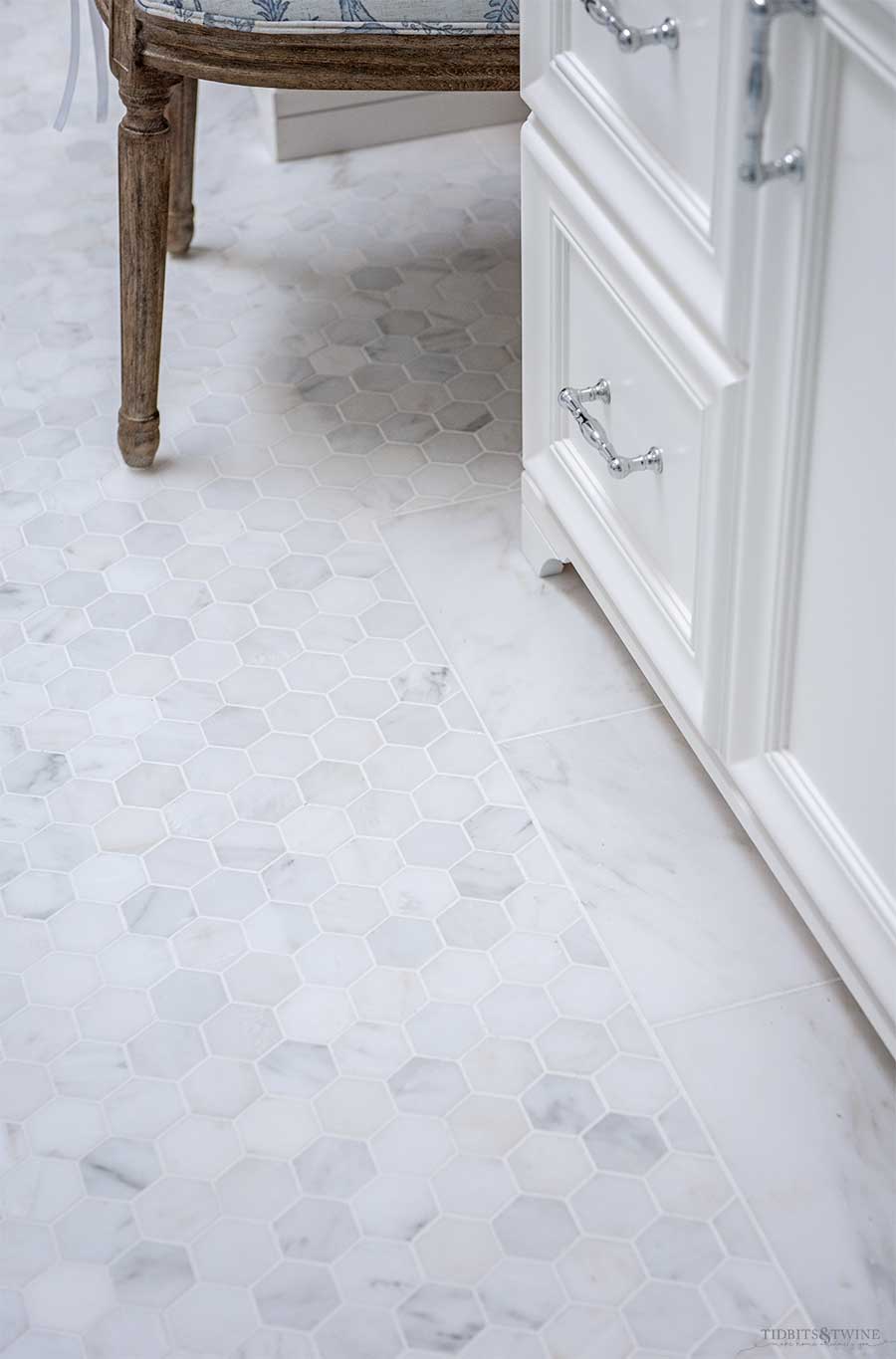 Venato Carrara marble hexagon floor with subway tile border in french elegant master bathroom