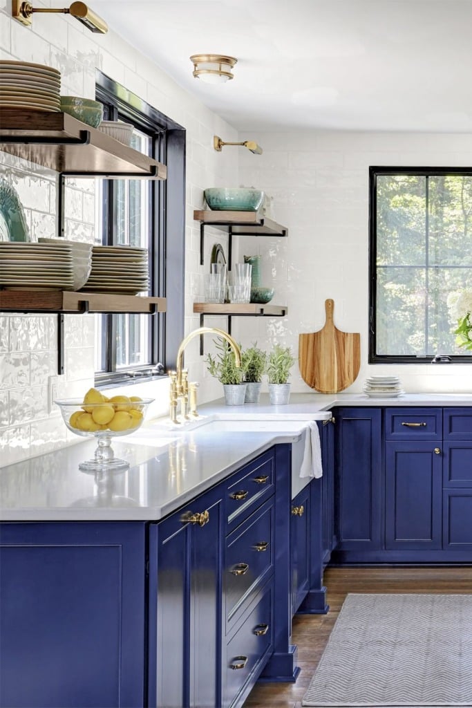 Contemporary kitchen with classic blue cabinets gold hardware and white countertop