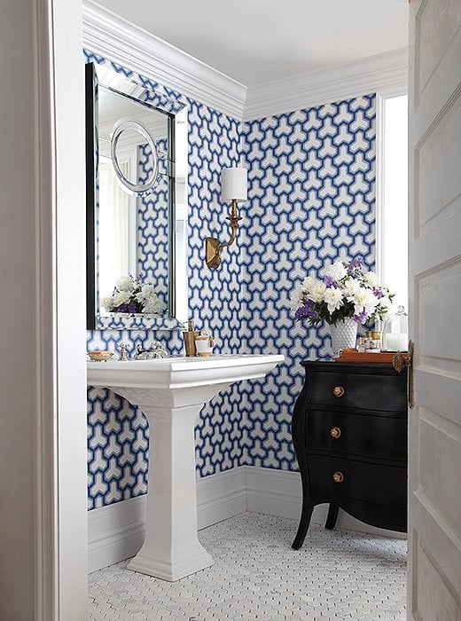 Bathroom with pedestal sink and blue and white wallpaper