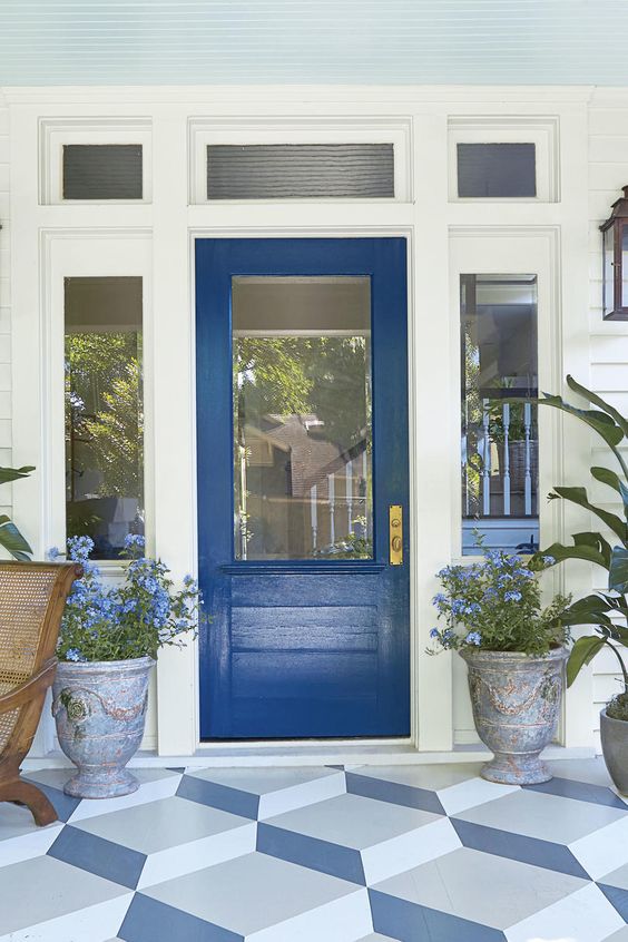 Classic blue front door with light blue beadboard ceiling