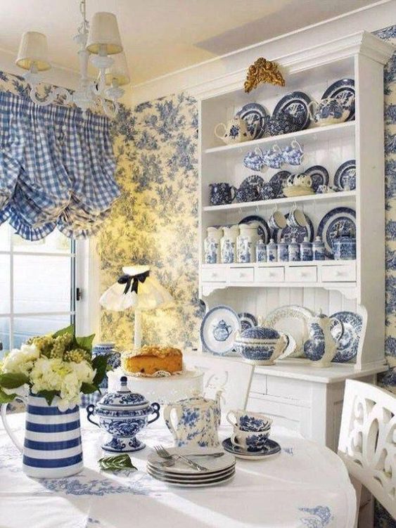 French country kitchen with classic blue checkered curtains and toile wallpaper