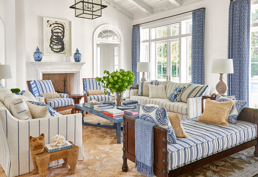 White and blue living room with stripes and green flower centerpiece