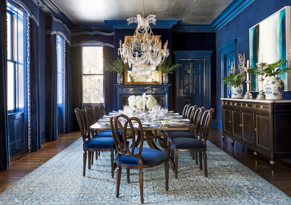 Formal dining room with blue walls and blue chairs