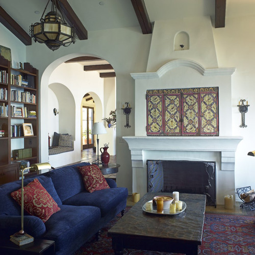 TV above fireplace with decorative doors