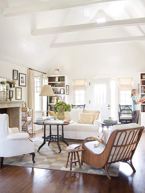 Eclectic mix of neutral furniture in living room with white sofa and black coffee table