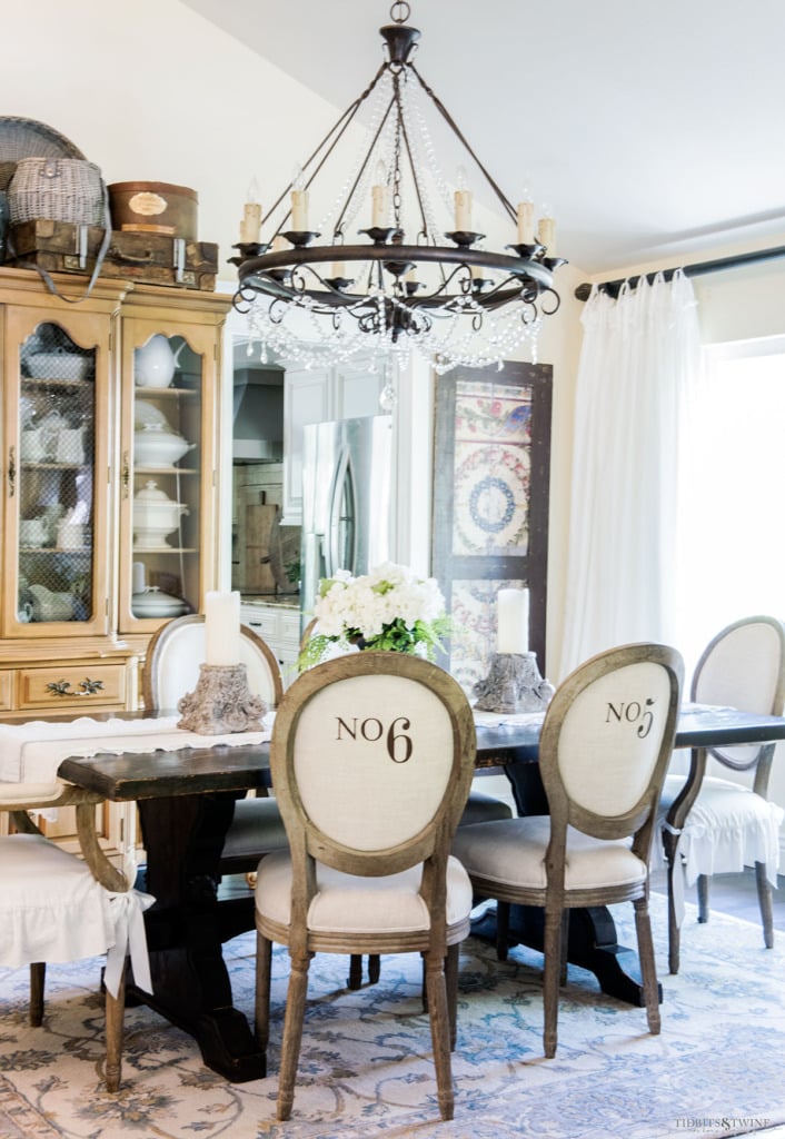 French dining room with numbered chairs and crystal chandelier