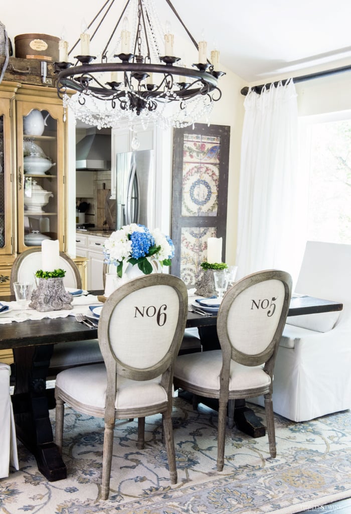 French dining room Spring decor with white slipcovered head chairs and numbered side chairs