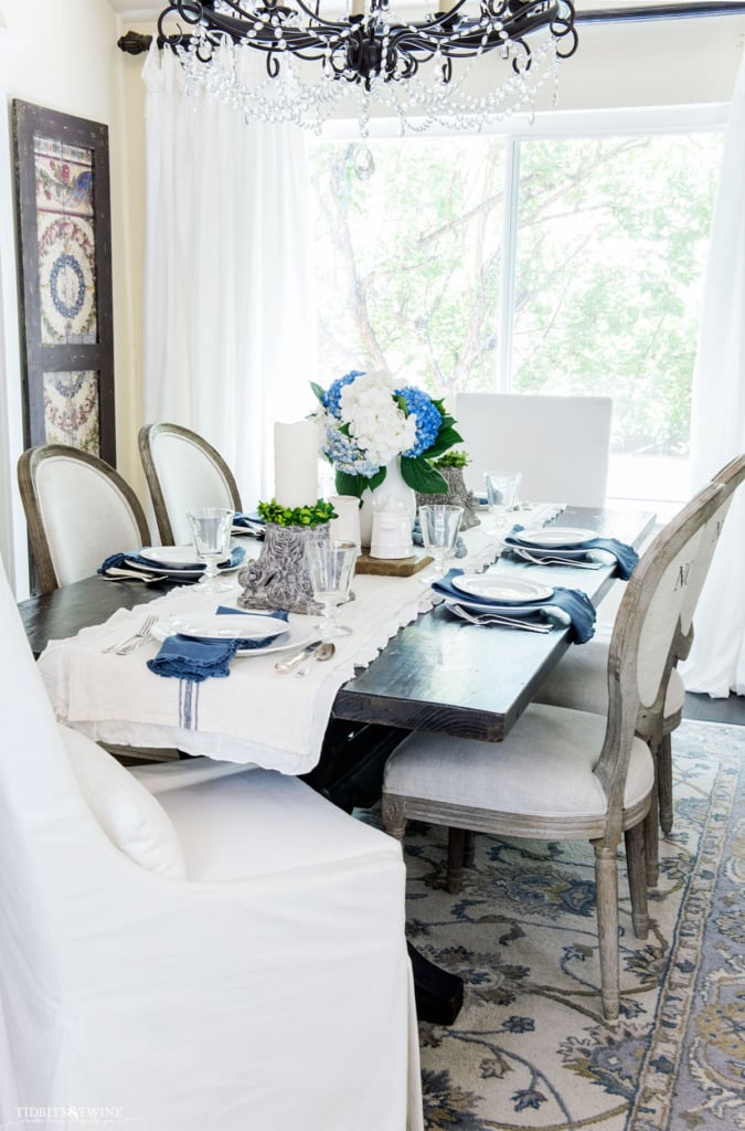 French dining room with blue and white setting and mismatched chairs