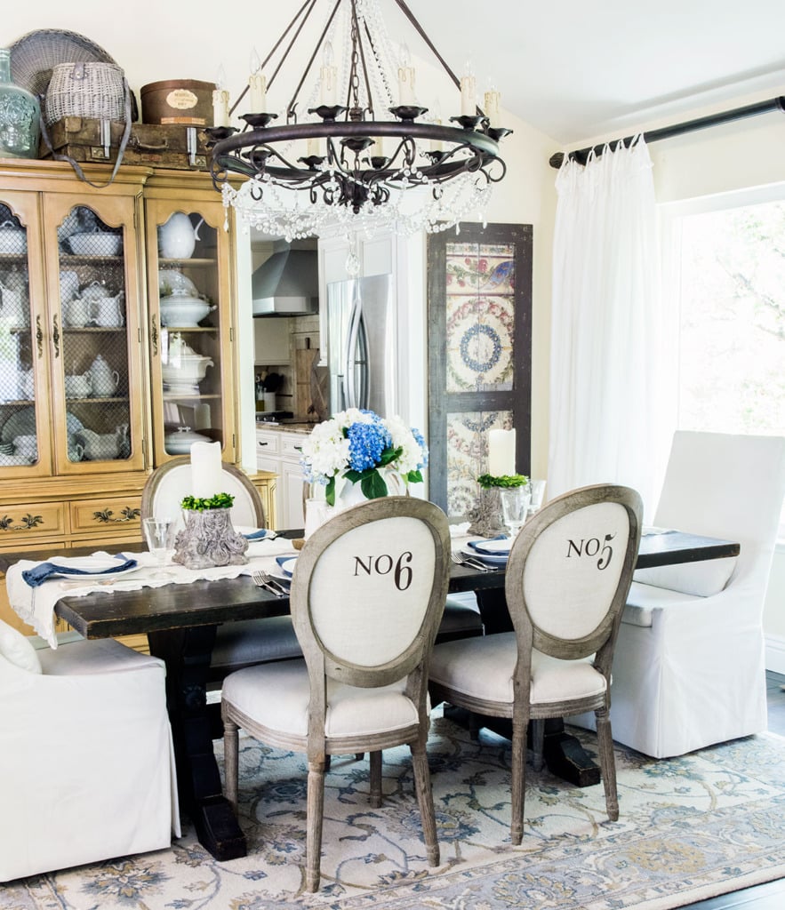 French dining room with numbered side chairs and white slipcovered head chairs