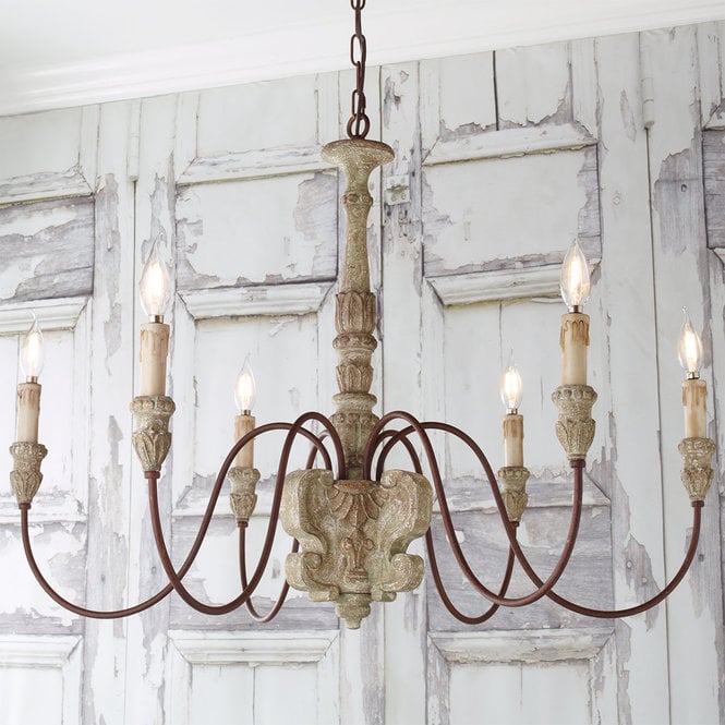 Rustic French chandelier with six lights and carved wood column and wax candles