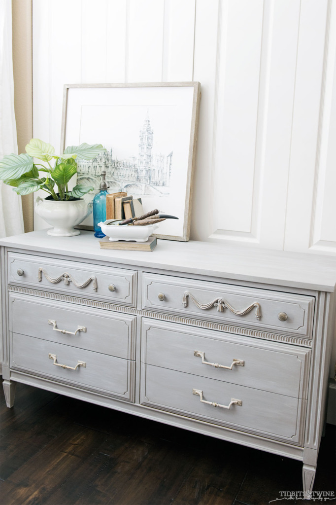 Gray chalk painted French dresser with plant and book vignette on top