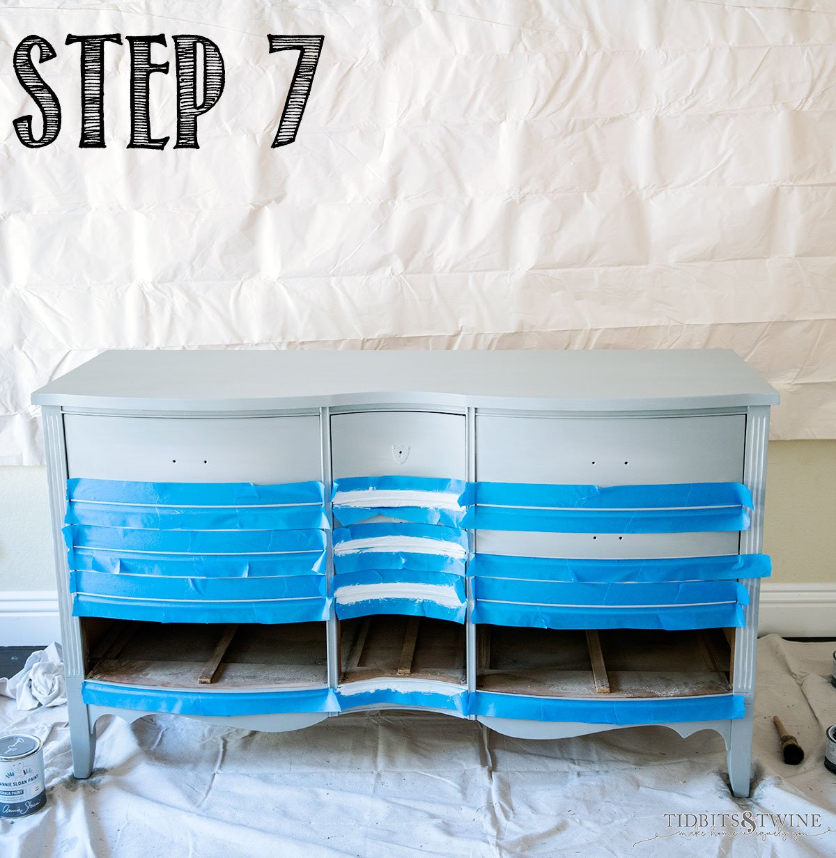 Antique dresser painted gray blue and taped off to paint white highlights