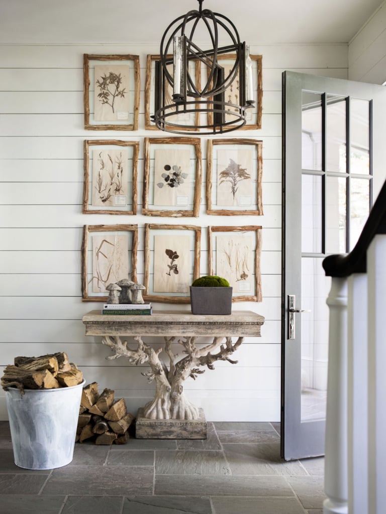 Foyer with rustic tree console table and branch framed gallery wall