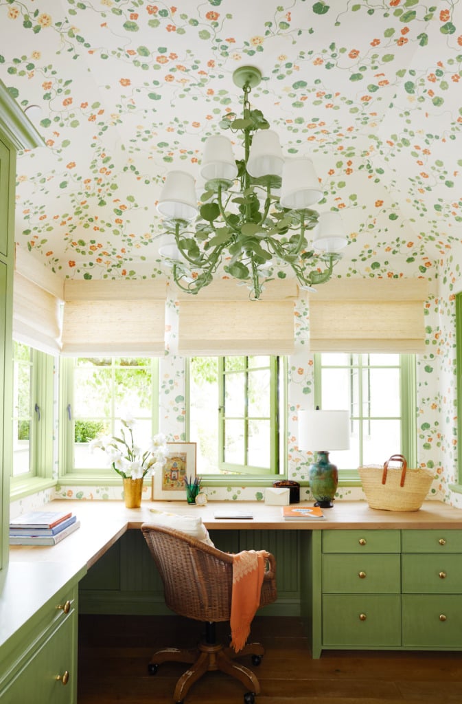 green built-in corner desk home office with green and orange floral wallpaper