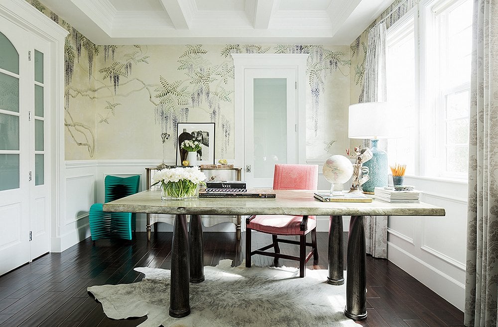 Home office in a dining room with wisteria wallpaper and cowhide rug