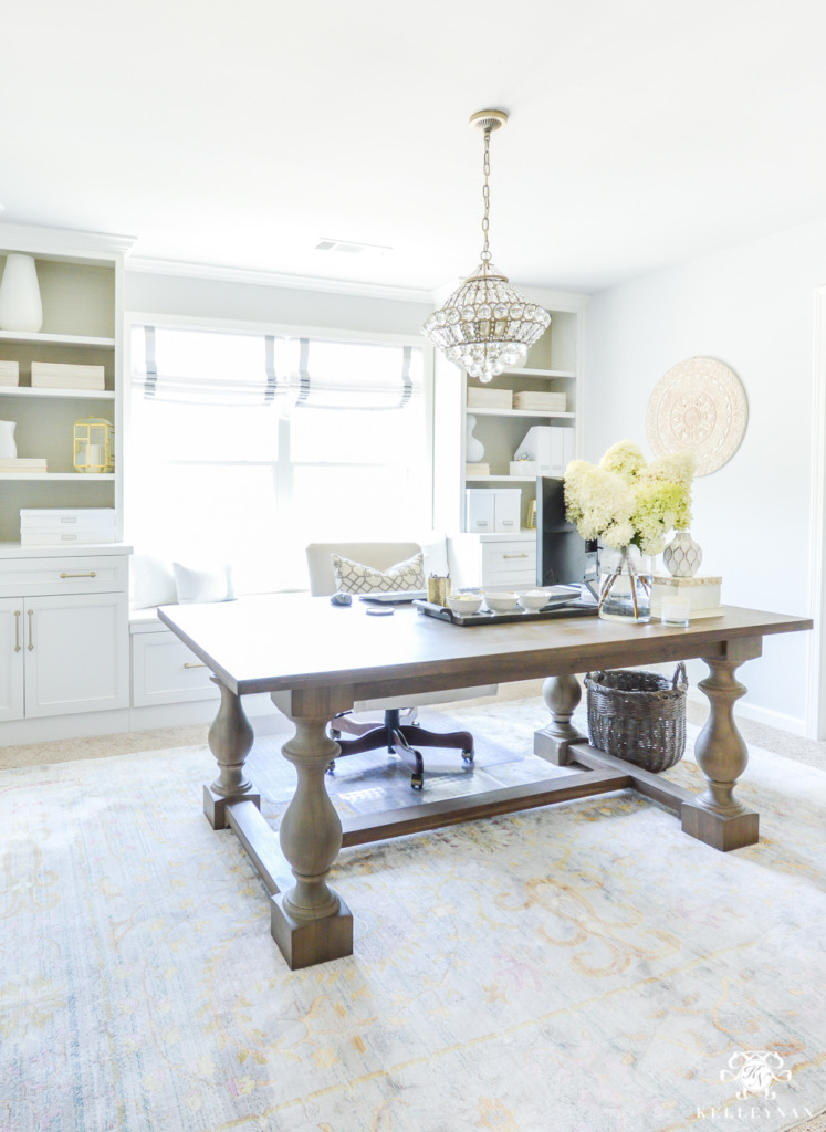 bright pretty home office with dining table desk and built-ins around window