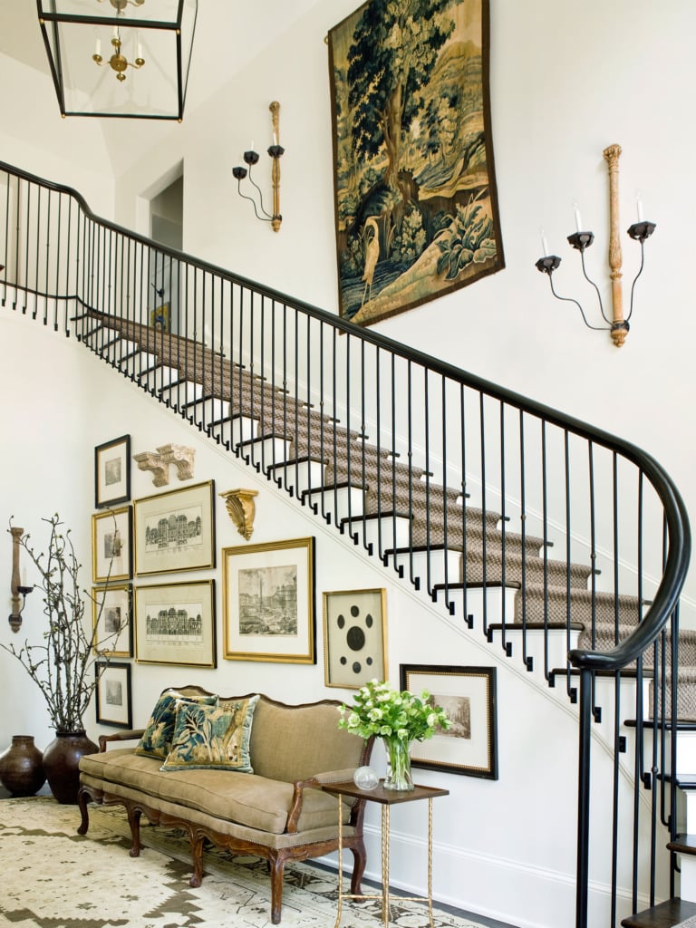 entryway with large staircase vintage gallery wall and french sconces