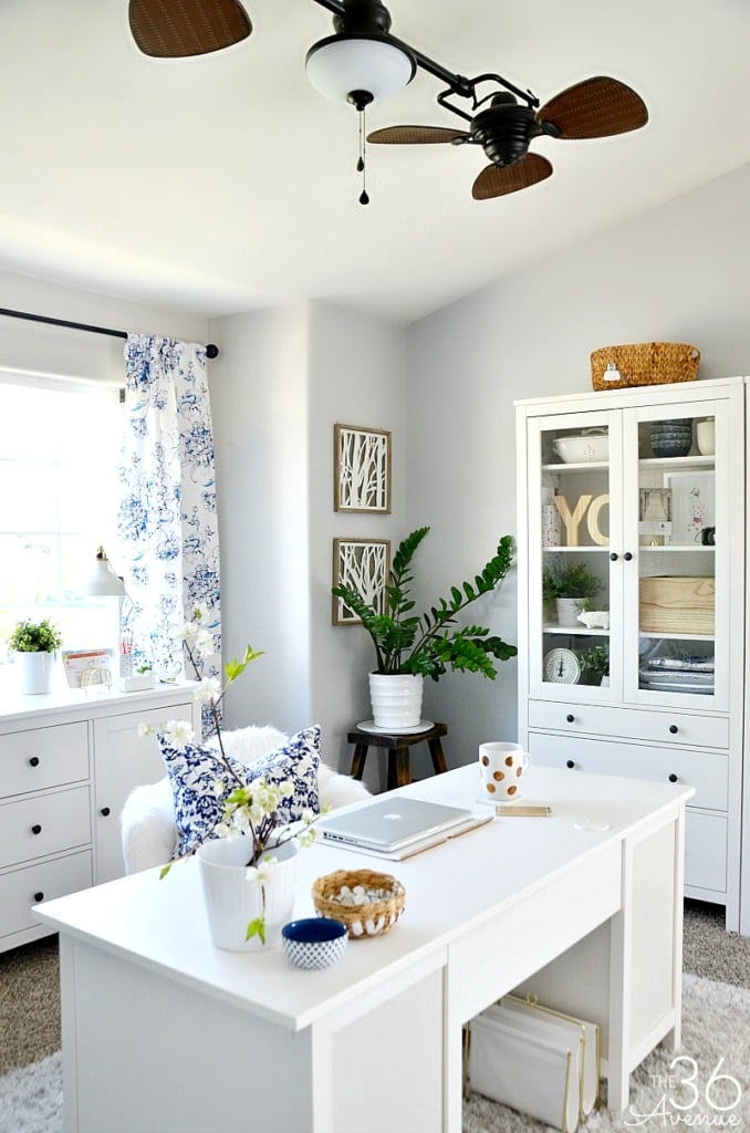 stylish home office with white desk and blue accents