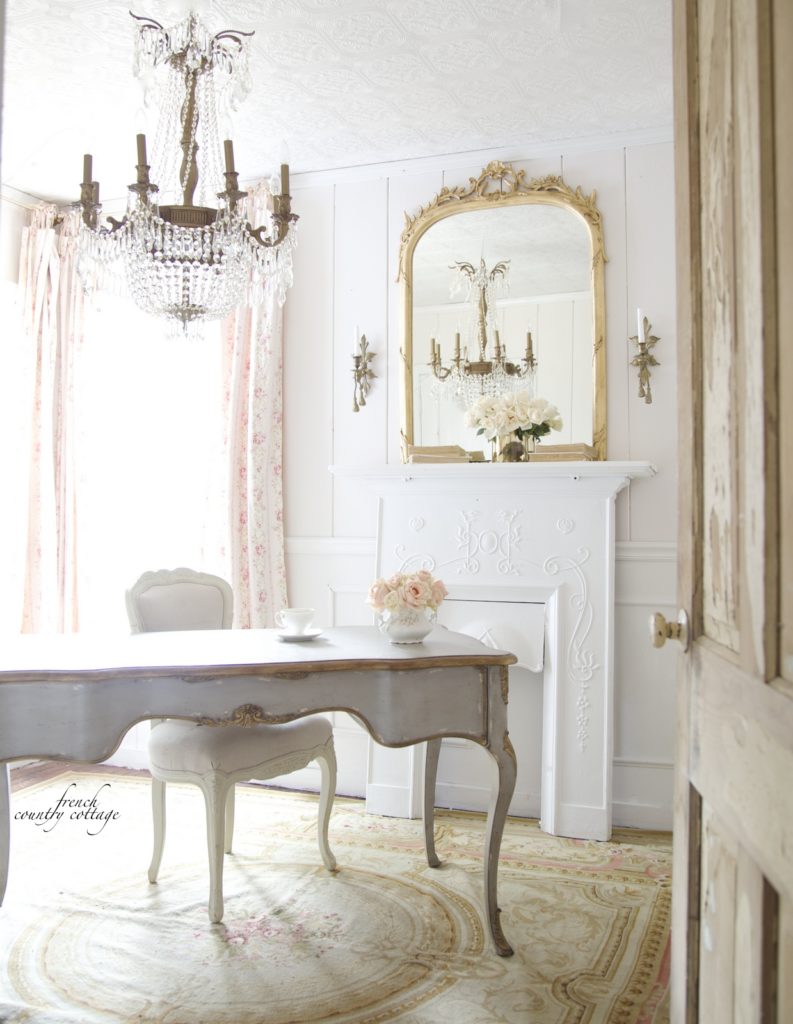 French romantic home office with gray desk fireplace and crystal chandelier