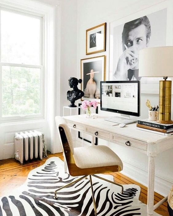 french contemporary home office with gallery wall above desk and zebra rug