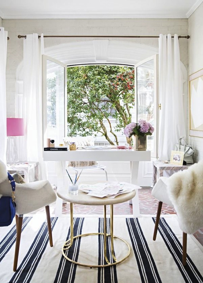 feminine home office with white desk in front of french doors