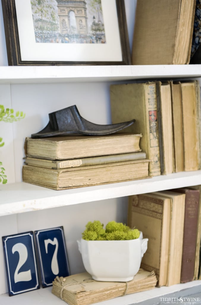 Collection of antique books on display in a french cabinet