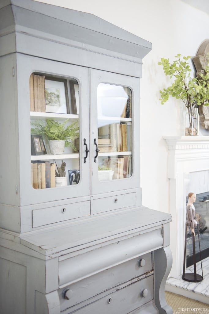 Blue empire hutch desk with styled shelves in a living room