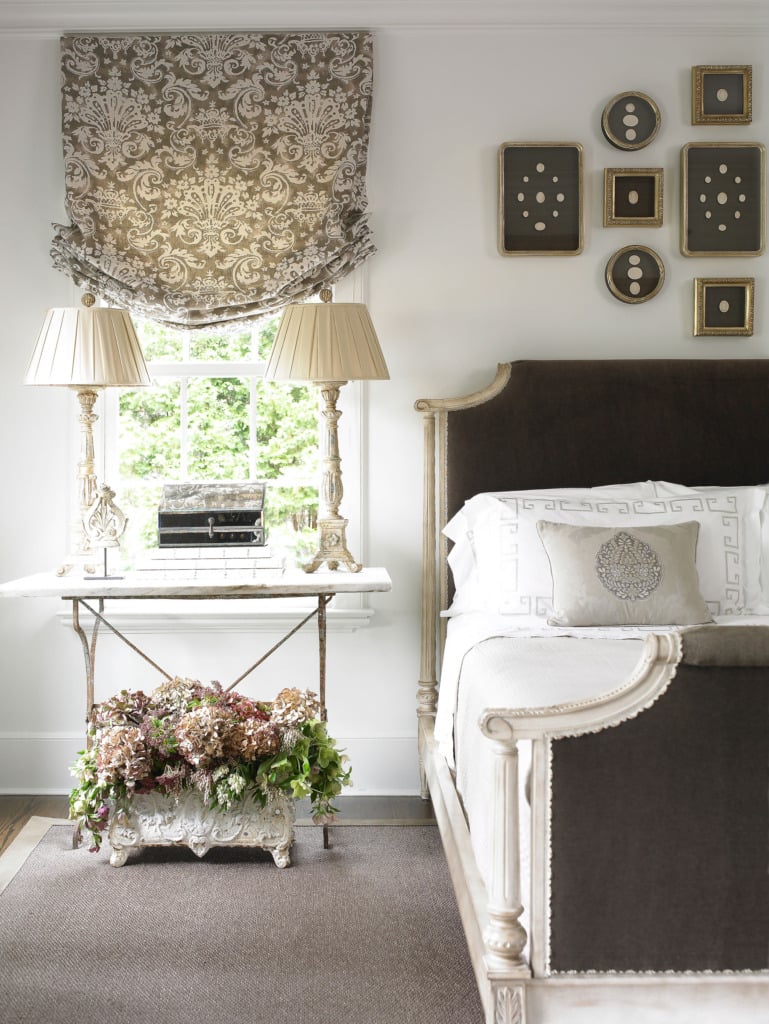 french master bedroom with brown velvet bed and table as a nightstand