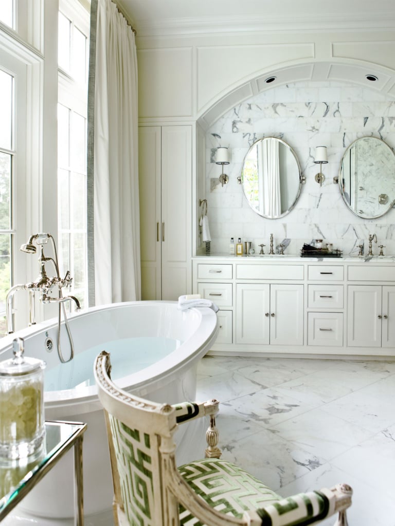 marble master bathroom with freestanding tub overlooking window