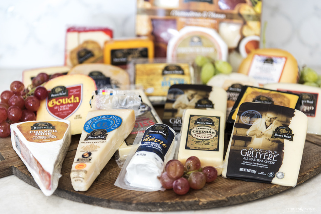 All of the Boar's Head cheeses shown on a rustic round board