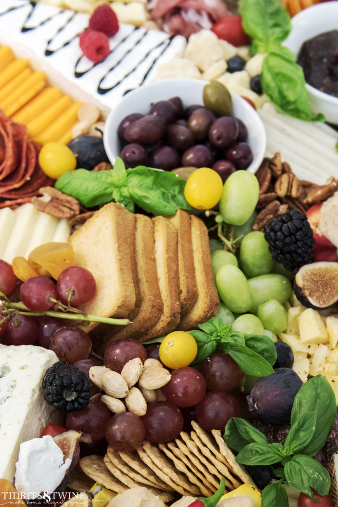 Closeup of meat and cheese charcuterie board showing grapes and marcona almonds