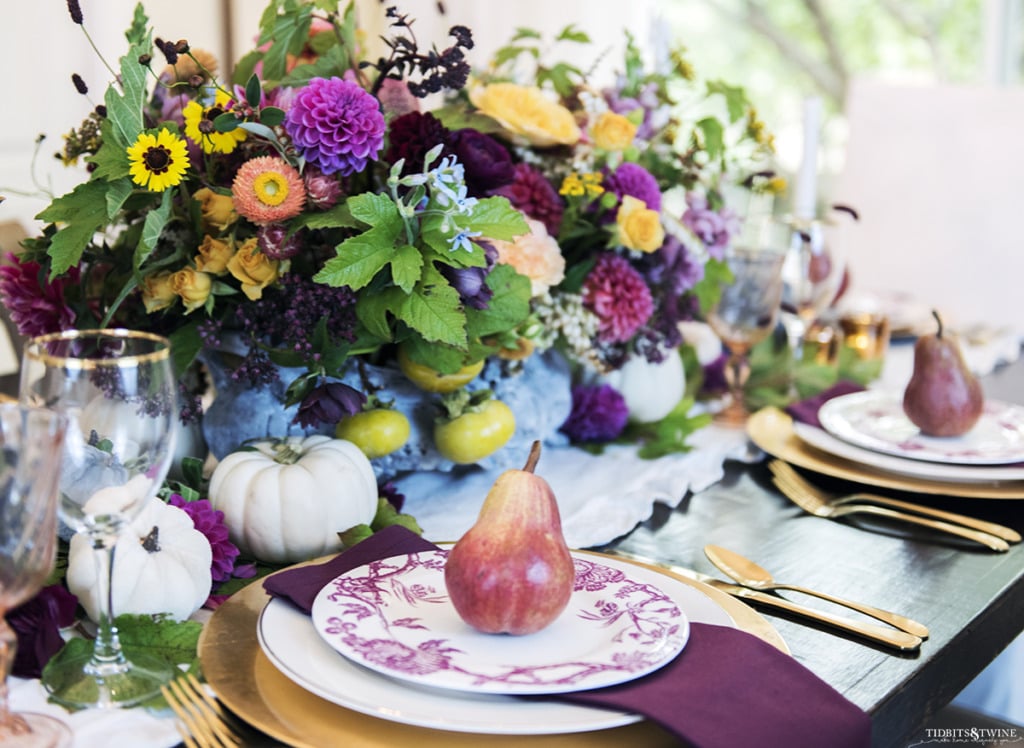 fall table with gold and burgandy and large jardinere with flowers