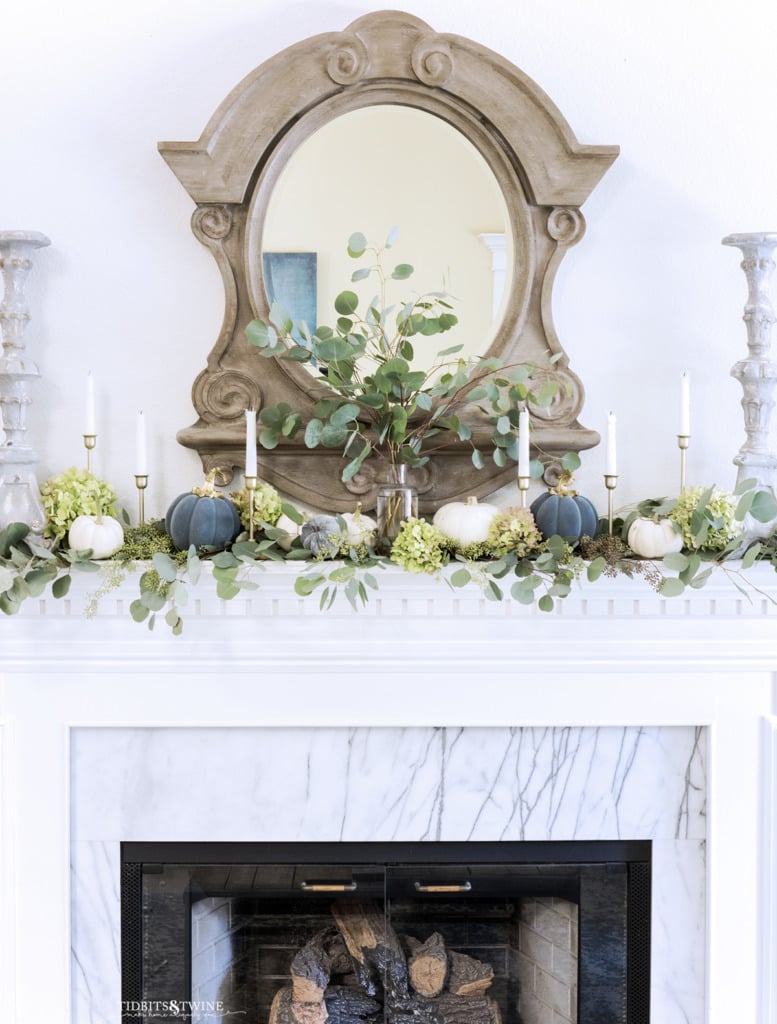 French living room mantel decorated for Fall with eucalyptus candles and little pumpkins