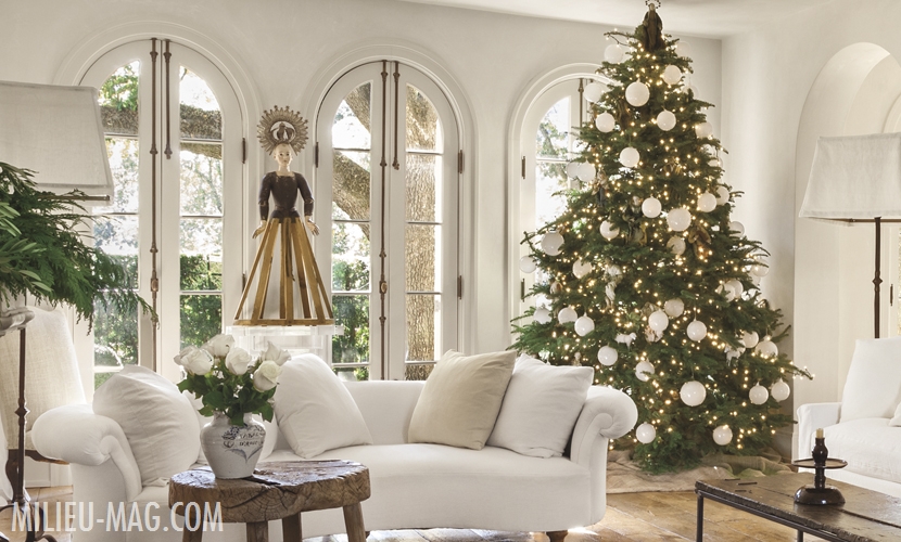 Living room with white sofas and large christmas tree with white ornaments