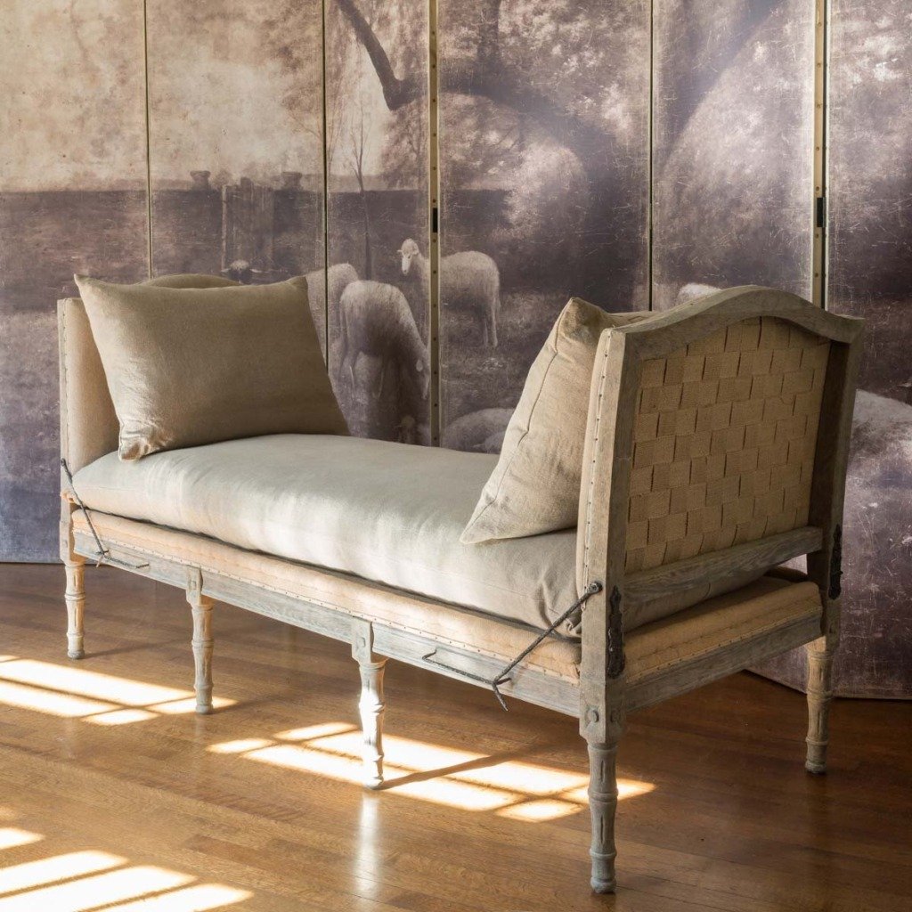 french daybed with beige linen cushion and burlap base and two linen cushions