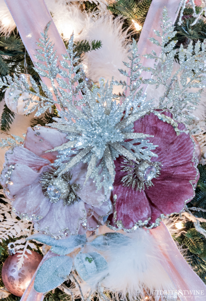 Pink silver and gold floral centers on crisscross ribbon on a French Christmas tree