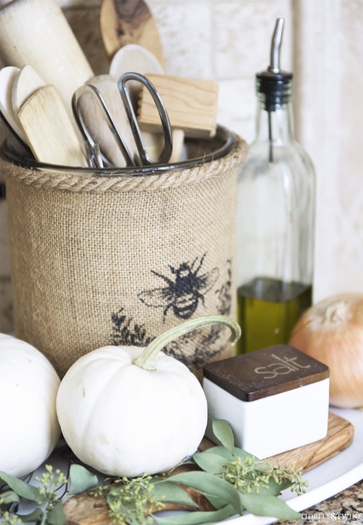 Burlap vase kitchen utensil holder with white pumpkins decorated for Fall