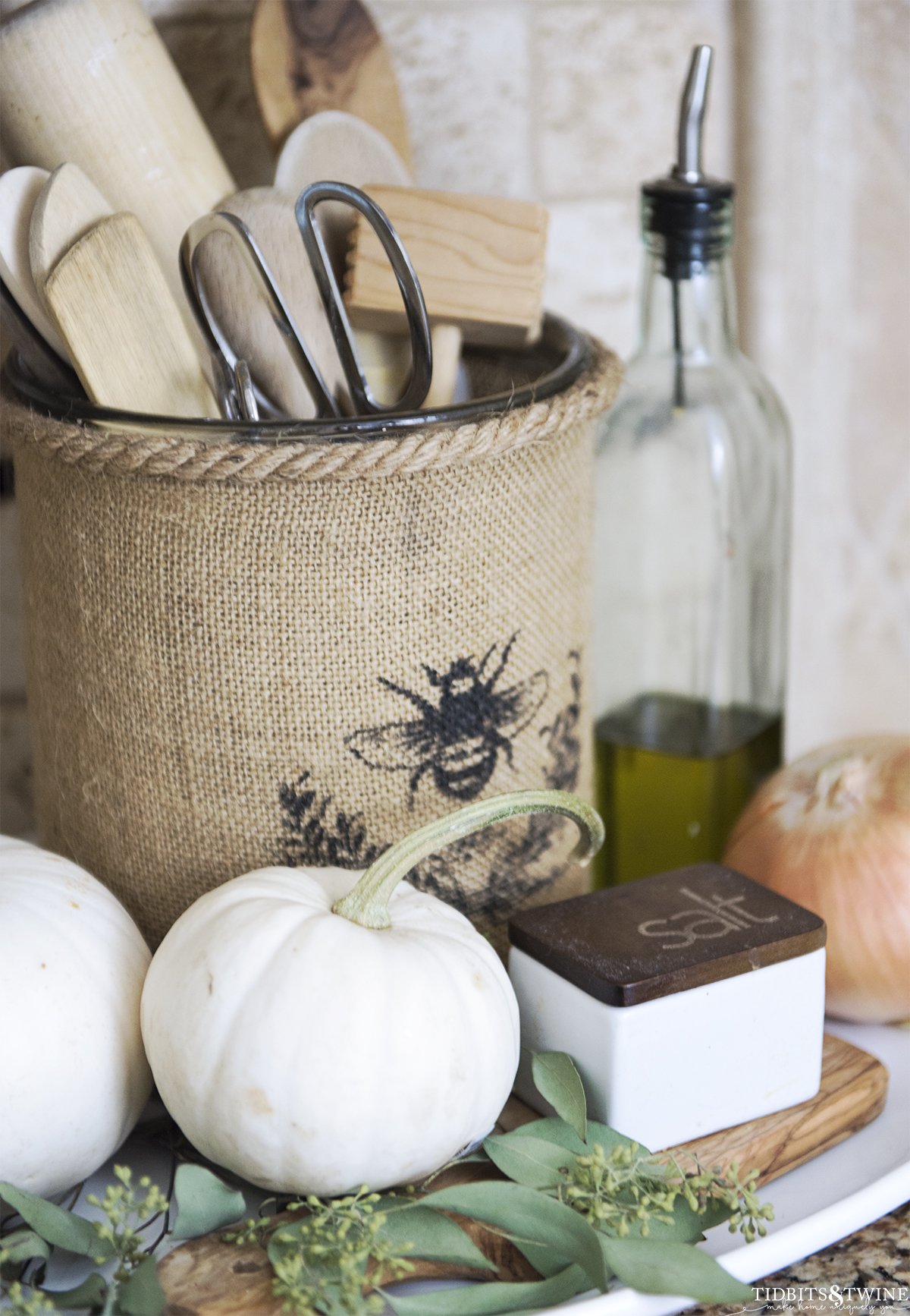 Burlap vase kitchen utensil holder with white pumpkins decorated for Fall