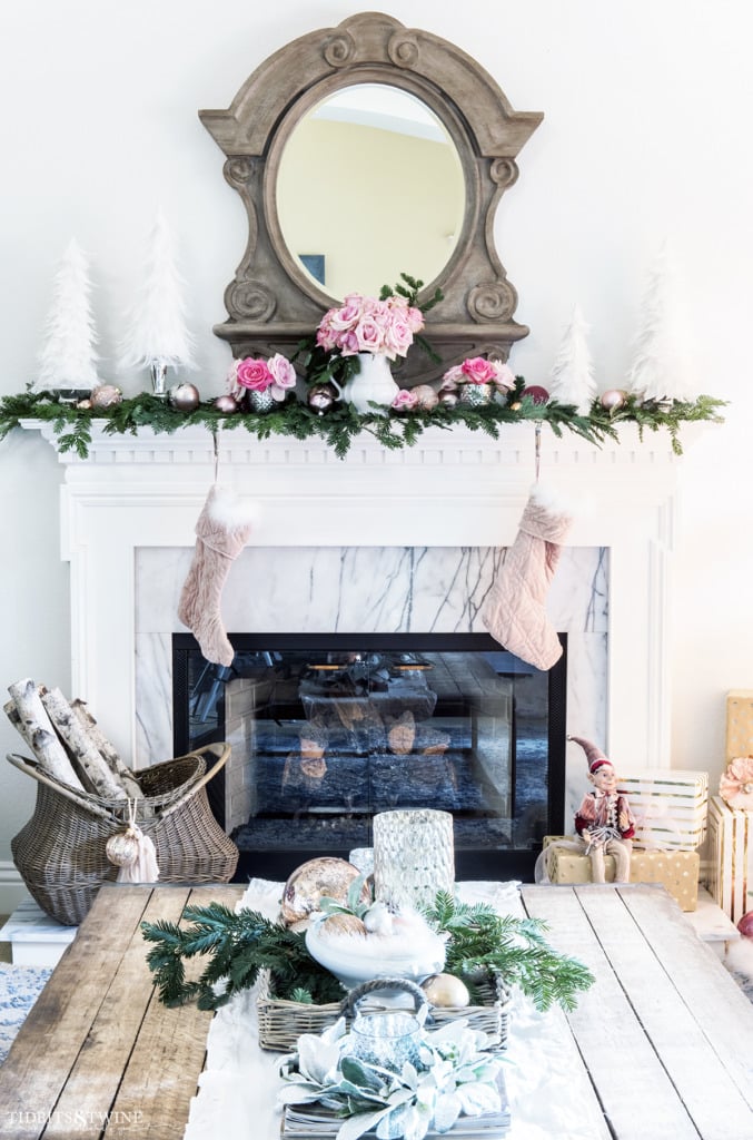 Living room Christmas fireplace mantel with French mansard mirror above in pink and white