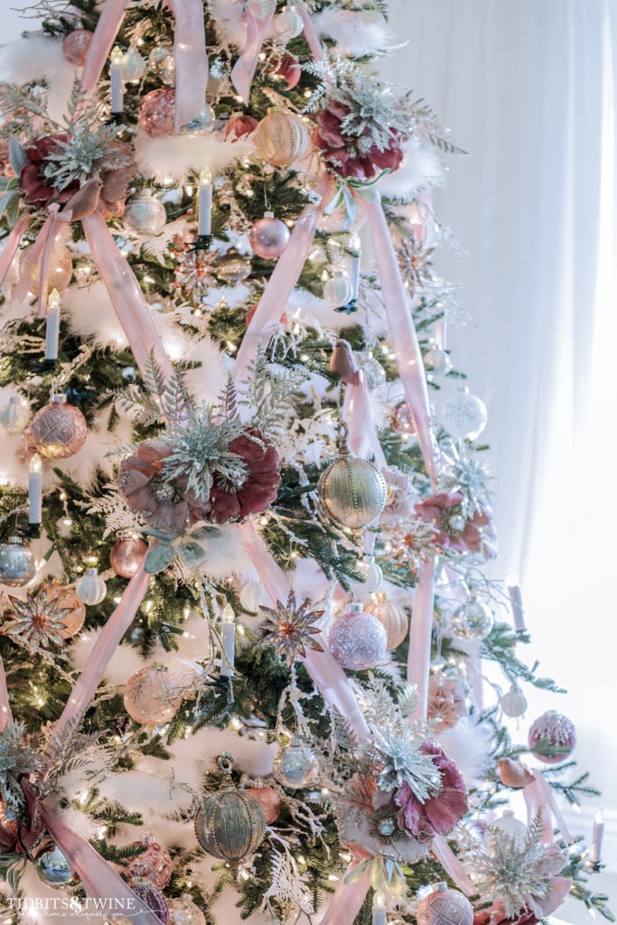 Pink Christmas tree with velvet ribbon and white accents.