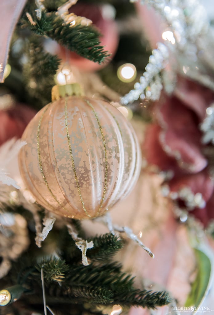 Closeup of a pink and gold Christmas ornament ball