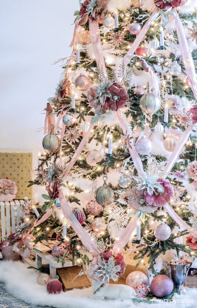 Christmas tree decorated in pink gold silver and white with crisscross ribbon