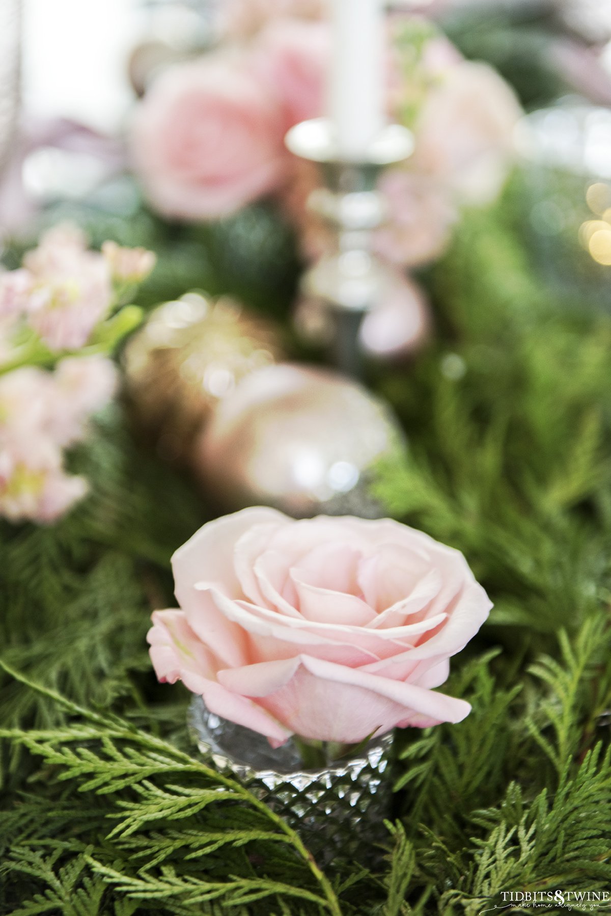 Pink Christmas table with cedar garland pink roses pink ornaments and white candles