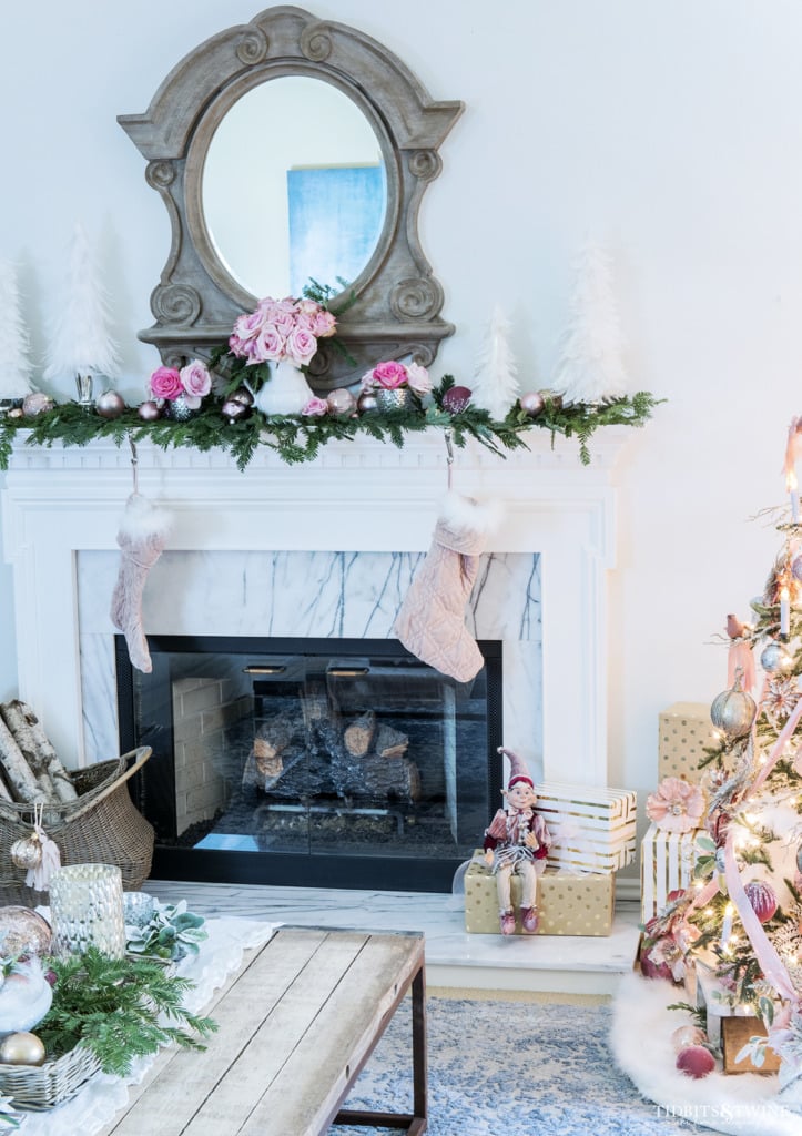 Living room fireplace decorated for Christmas in pinks and white