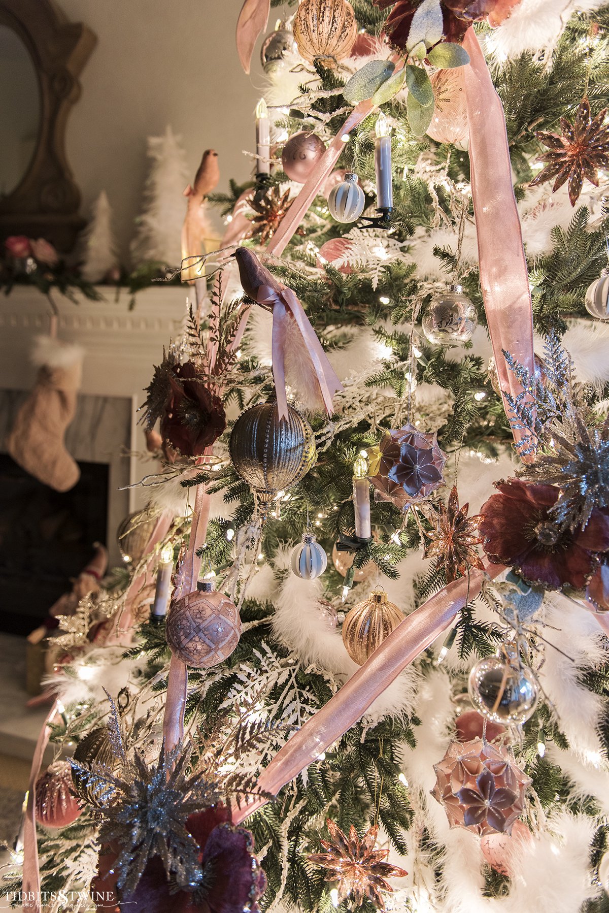 French pink Christmas tree with crisscross ribbon and fireplace in the background