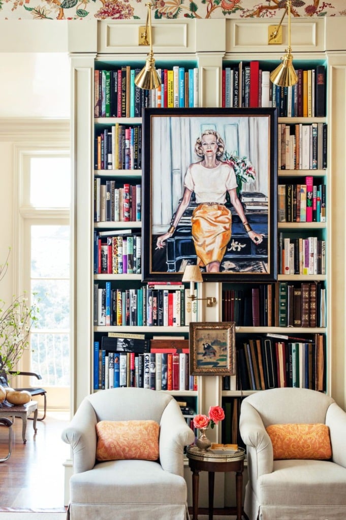 decorating cabinets with artwork hanging from frame of white bookcase