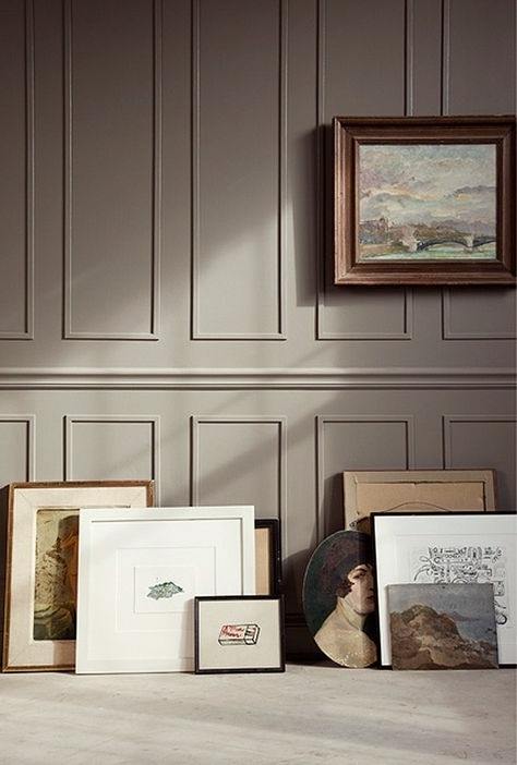 Benjamin Moore Kingsport Gray painted wall with picture frames laying on the ground