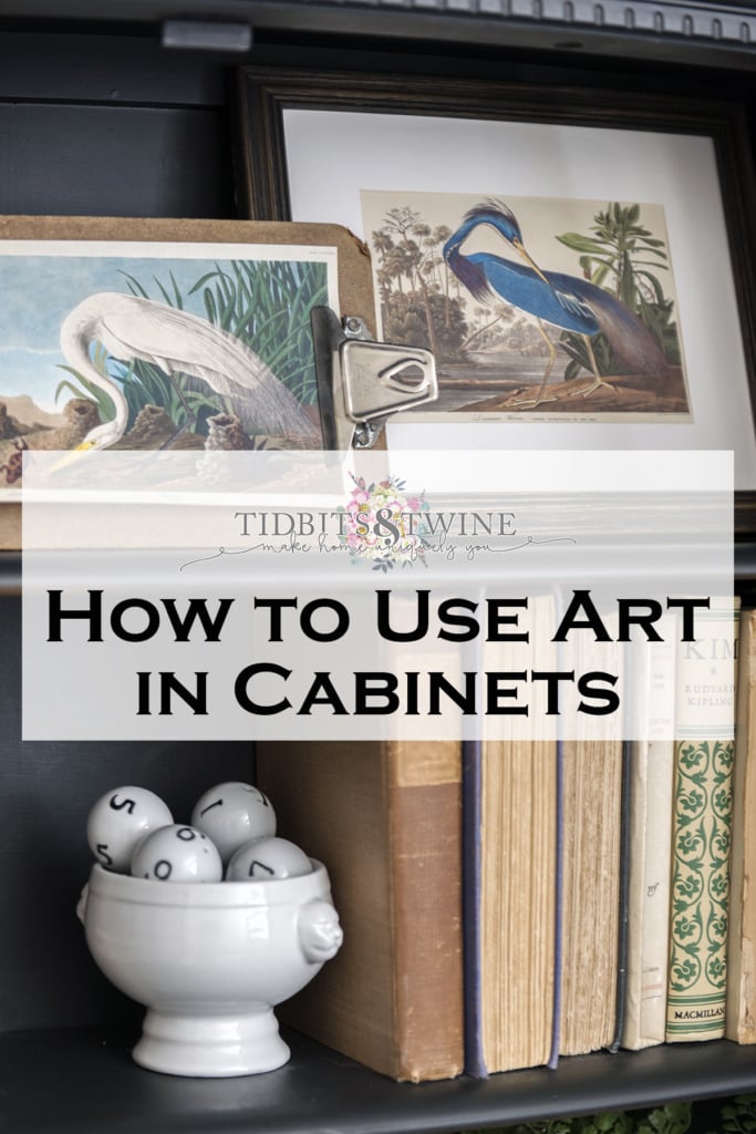 Black cabinet styled with books and artwork