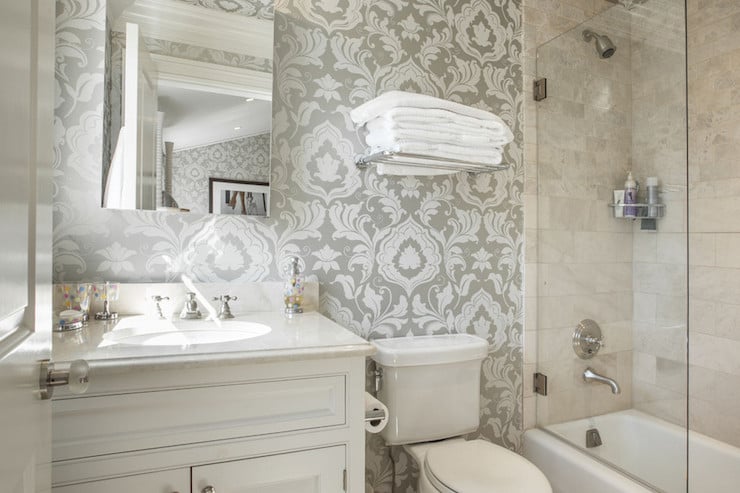Small bathroom with beige wallpaper and white single sink